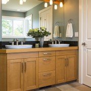 Bathroom vanity with wood cabinets, double sinks, slate tile flooring remodel | Avon, OH | North Star Premier Custom Homes