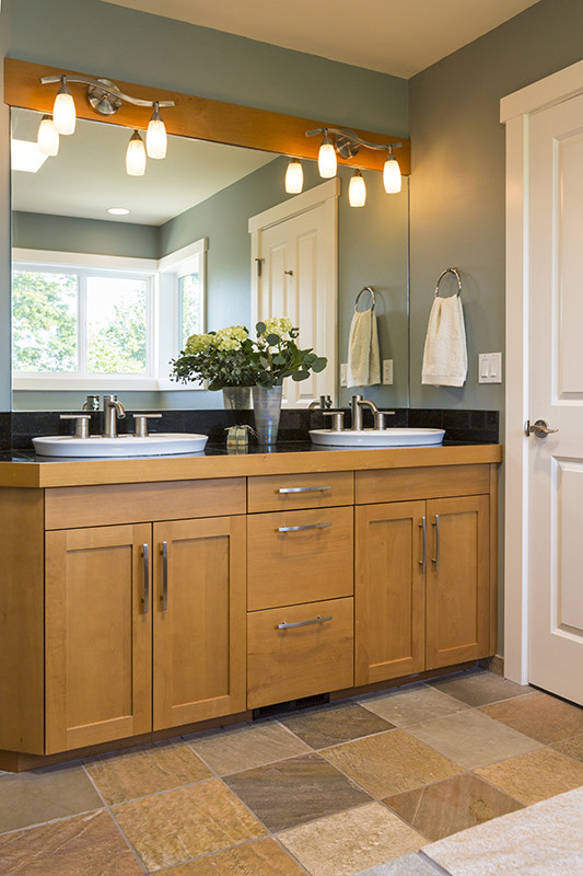 Bathroom vanity with wood cabinets, double sinks, slate tile flooring remodel | Avon, OH | North Star Premier Custom Homes