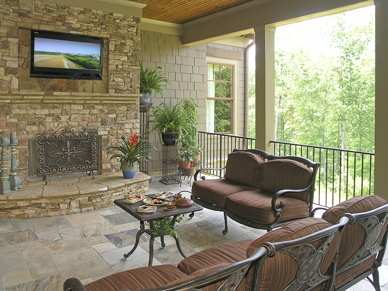 Custom outdoor living area with fire place feature | Avon, OH | North Star Premier Custom Homes